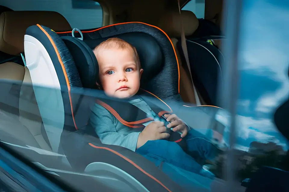 Baby in a child seat during a taxi transfer in Morocco